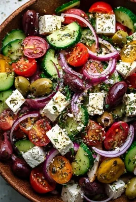 Bowl of vibrant Greek Salad with tomatoes, cucumbers, olives, and feta cheese