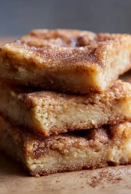 Freshly baked cinnamon sugar blondies with a sprinkle of cinnamon on top