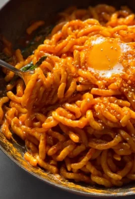 Creamy Gochujang Pasta topped with fresh herbs and veggies