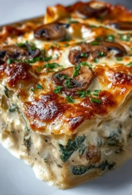 Creamy spinach mushroom lasagna fresh out of the oven with melted cheese