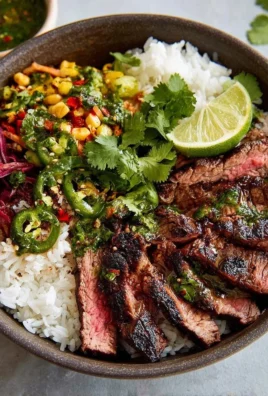 Flank Steak Bowl with grilled flank steak, fresh vegetables, and rice in a bowl.