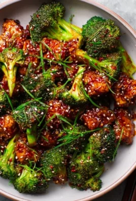 Plate of spicy Gochujang Broccoli garnished with sesame seeds.