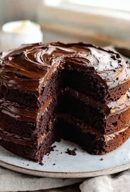 Delicious slice of Matilda's Chocolate Cake topped with chocolate ganache.