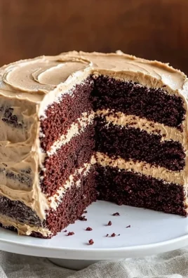 Moist chocolate layer cake with coffee buttercream icing displayed on a cake stand