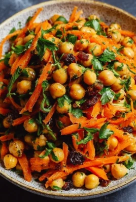 Vibrant Moroccan Carrot and Chickpea Salad garnished with fresh herbs