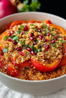 Bowl of muhammara dip made with roasted red peppers and walnuts