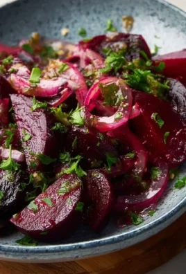 Colorful pickled beet salad with fresh ingredients in a bowl