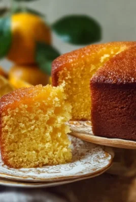 Sicilian Whole Orange Cake topped with fresh oranges and garnished with powdered sugar