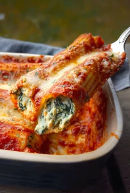 Delicious Spinach Cheese Manicotti served with marinara sauce and herbs