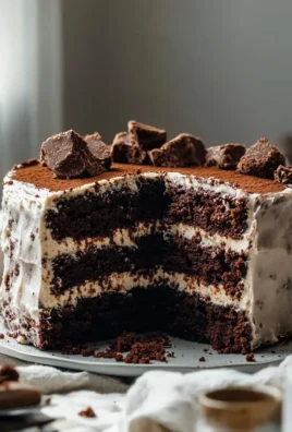 Decadent brownie cake topped with chocolate frosting and walnuts.
