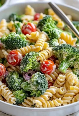 Delicious bowl of broccoli pasta salad with fresh veggies and dressing.