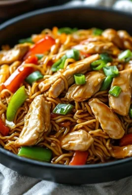 Delicious plate of Chicken Chow Mein with vegetables and chicken strips