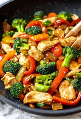 Colorful chicken stir fry with vegetables in a skillet