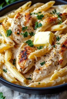 Creamy Crac Chicken Penne served in a bowl with fresh herbs