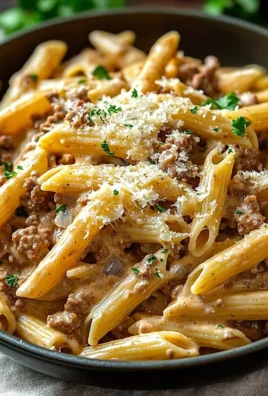 Delicious creamy beef pasta served in a bowl, topped with herbs