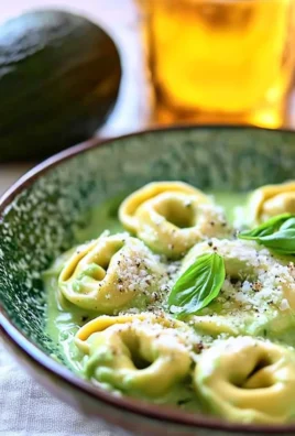 Creamy California avocado tortellini dish garnished with fresh herbs