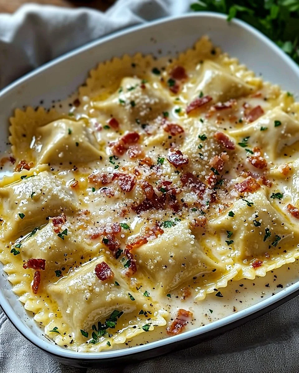 Plate of creamy Carbonara Ravioli topped with cheese and herbs