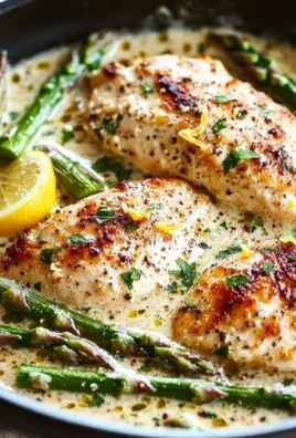 Creamy lemon chicken dish served with fresh asparagus
