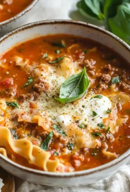 Bowl of easy creamy lasagna soup topped with cheese and herbs
