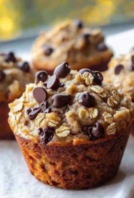 Freshly baked oatmeal chocolate chip muffins on a wooden table