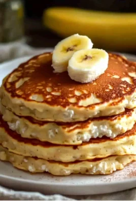 Fluffy banana pancakes with cottage cheese served on a plate