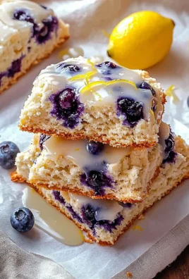 Fluffy blueberry scones with lemon glaze on a plate