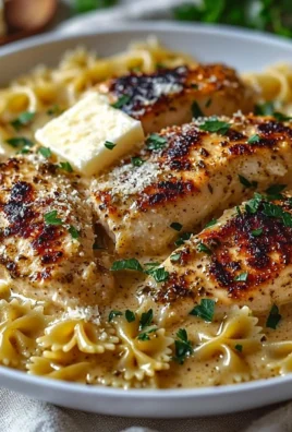 Delicious Garlic Butter Chicken with bowtie pasta served on a plate.