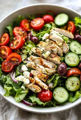Healthy Greek salad with chicken, fresh vegetables, and feta cheese