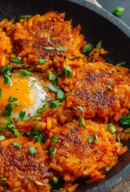 Healthy sweet potato hash browns served on a plate with herbs