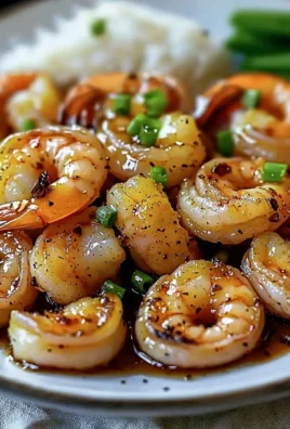 High-protein honey garlic shrimp served on a plate with garnishes.