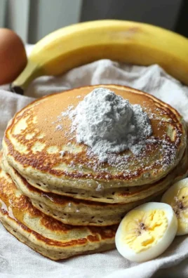 Healthy high protein pancakes stacked with fresh fruits on a plate