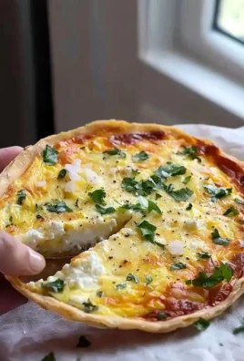 A slice of high protein quiche, gluten free, served with fresh vegetables.