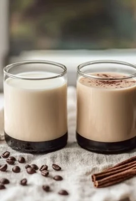 Homemade coffee creamer in a glass jar with ingredients on a wooden table