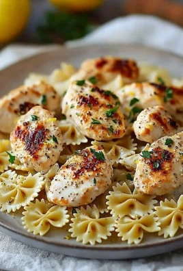 Lemon garlic chicken served with creamy bowtie pasta on a plate