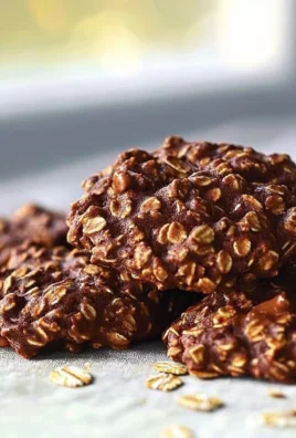 Plate of no bake chocolate oatmeal cookies stacked high.