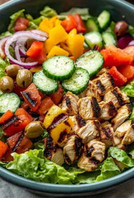 A colorful Peruvian grilled chicken salad featuring fresh vegetables and grilled chicken.