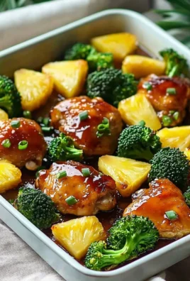 Sweet sheet pan pineapple chicken with broccoli on a baking sheet