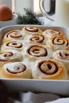 Freshly baked cinnamon rolls drizzled with icing, ready to enjoy