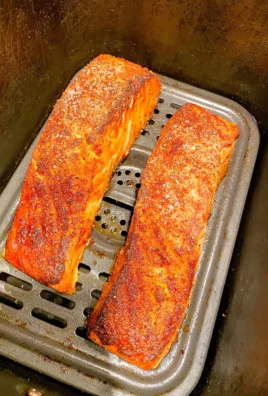 Delicious air fried salmon served on a plate with vegetables