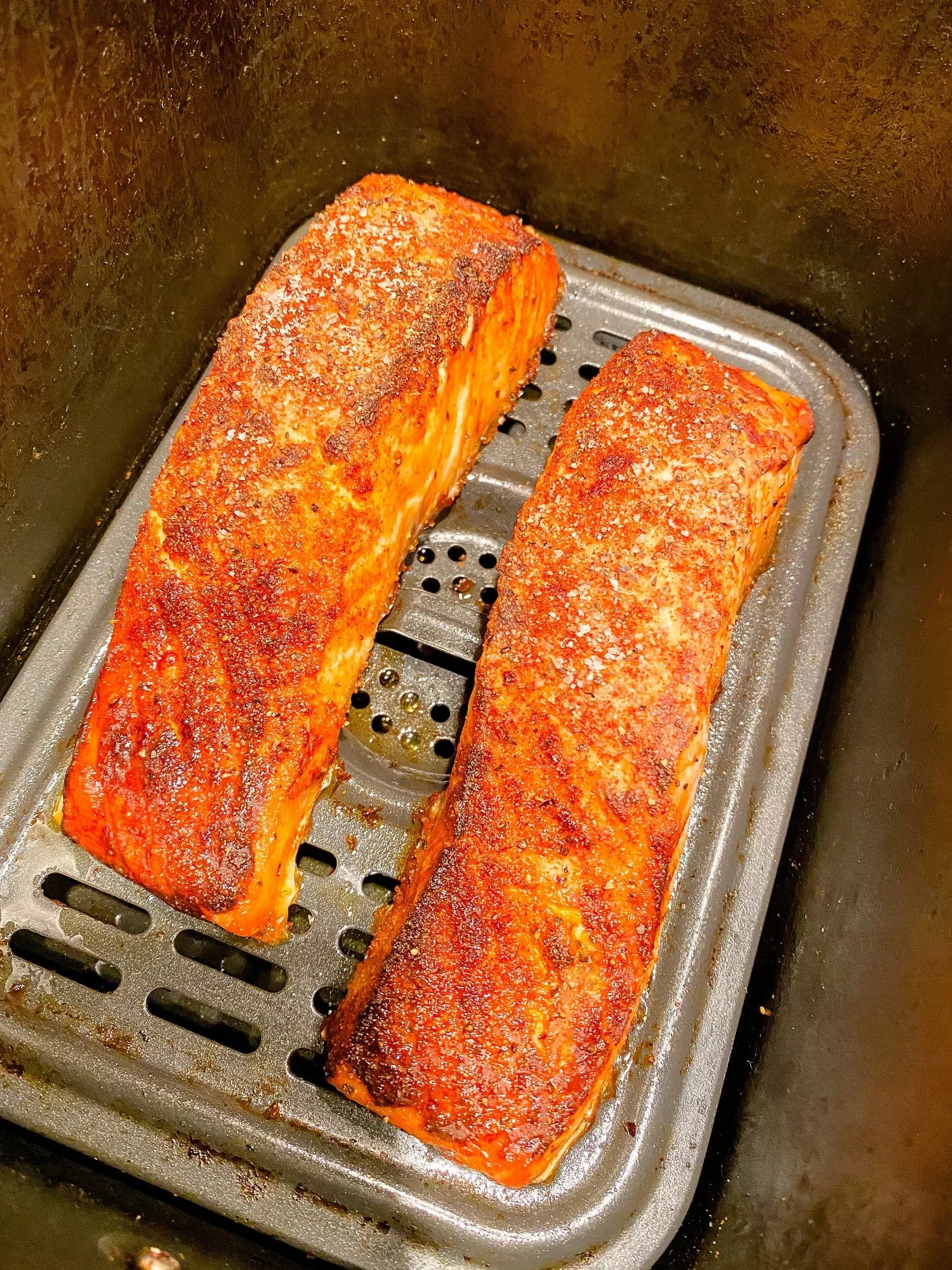 Delicious air fried salmon served on a plate with vegetables
