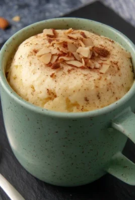 Almond-Cinnamon Protein Cheesecake Mug Cake served in a mug