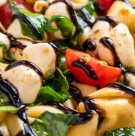 Delicious Caprese Salad with Tortellini, featuring fresh tomatoes and mozzarella