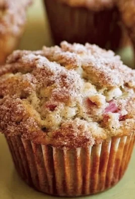 Freshly baked Cinnamon-Rhubarb Muffins on a wooden table