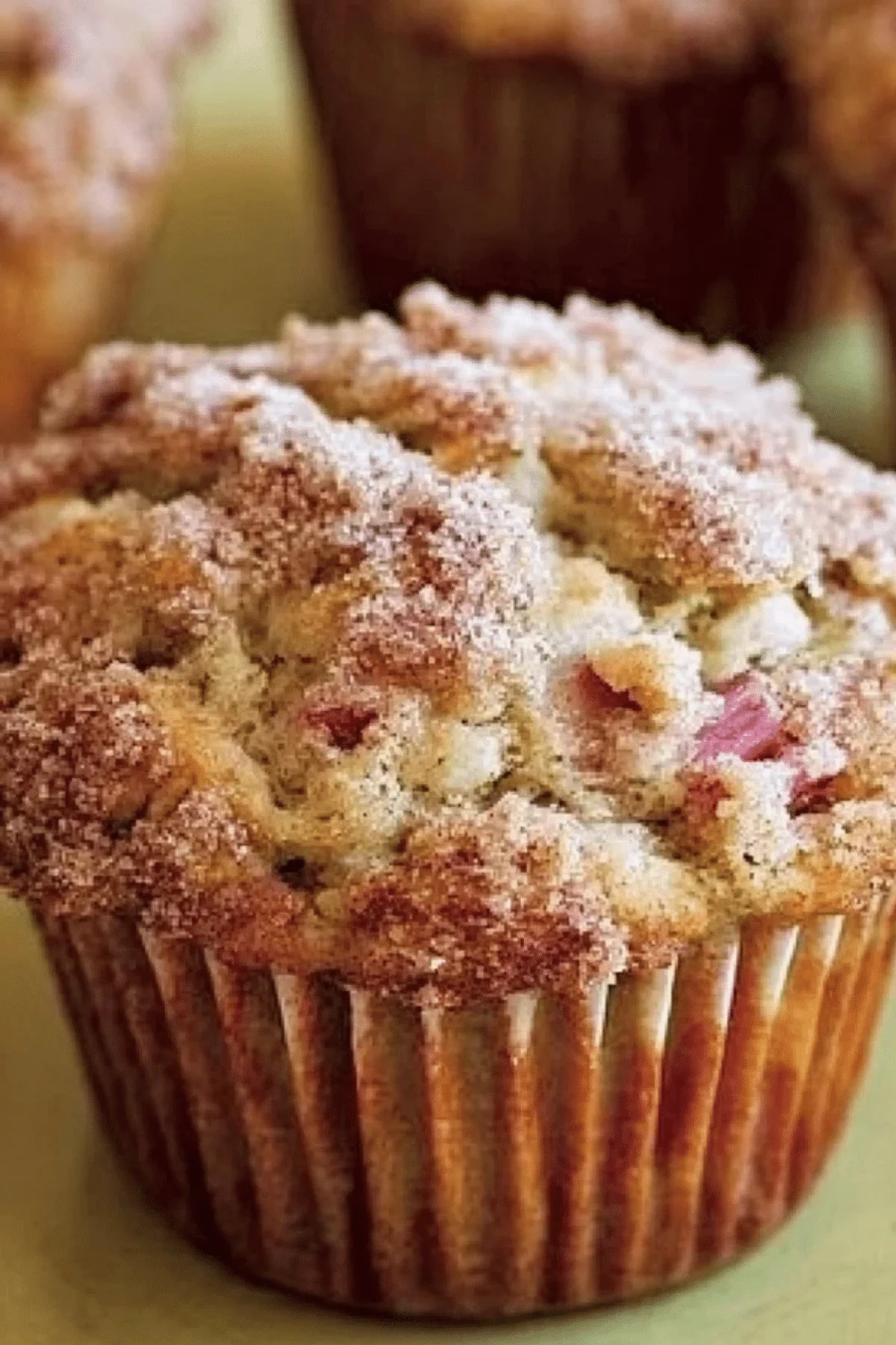 Freshly baked Cinnamon-Rhubarb Muffins on a wooden table