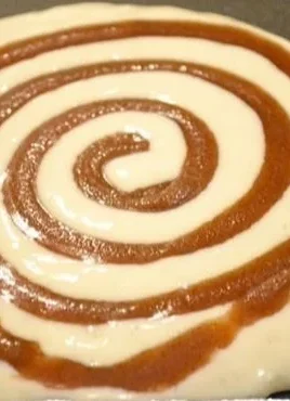 Fluffy cinnamon roll pancakes drizzled with icing on a plate