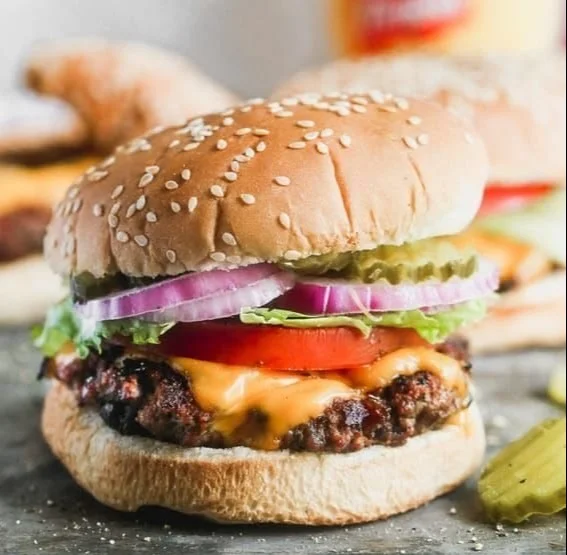 Delicious classic juicy hamburger served with fresh toppings