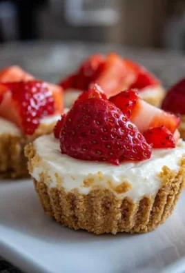 No-bake mini cheesecake cups topped with berries in a dessert dish