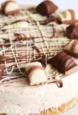 Delicious Kinder Bueno no-bake cheesecake topped with chocolate and hazelnuts