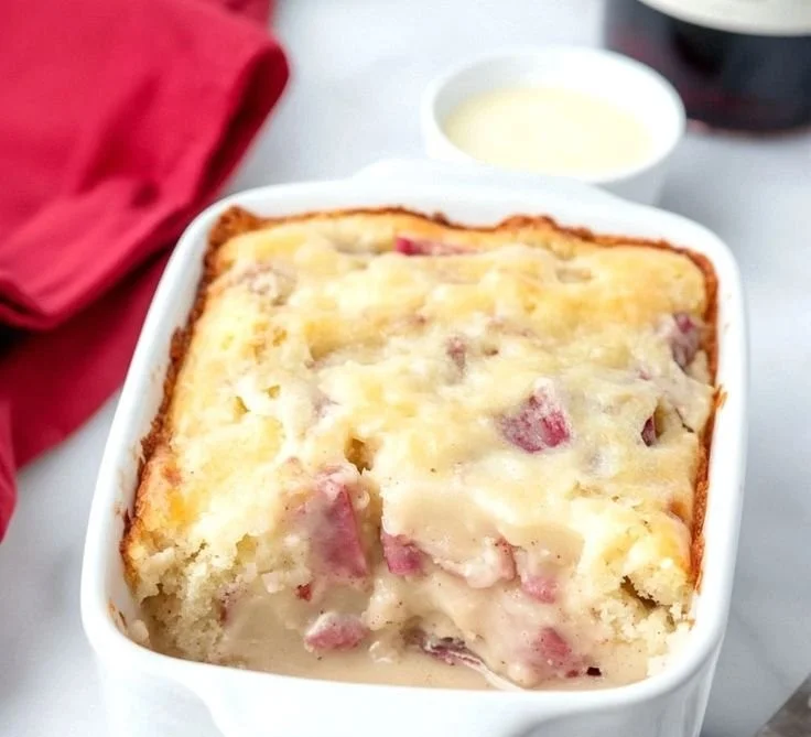 Slice of Moist Rhubarb Cake topped with rich butter sauce