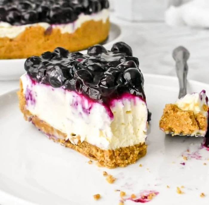 Delicious no bake blueberry cheesecake topped with fresh blueberries and whipped cream